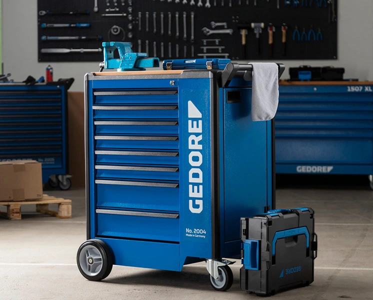 Blue GEDORE tool trolley with tool case in a workshop