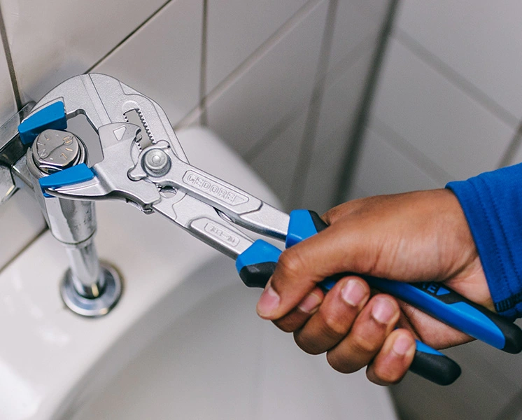 GEDORE water pump pliers used on a plumbing fitting