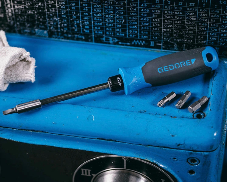 GEDORE bit holder screwdriver with several bits on a workbench