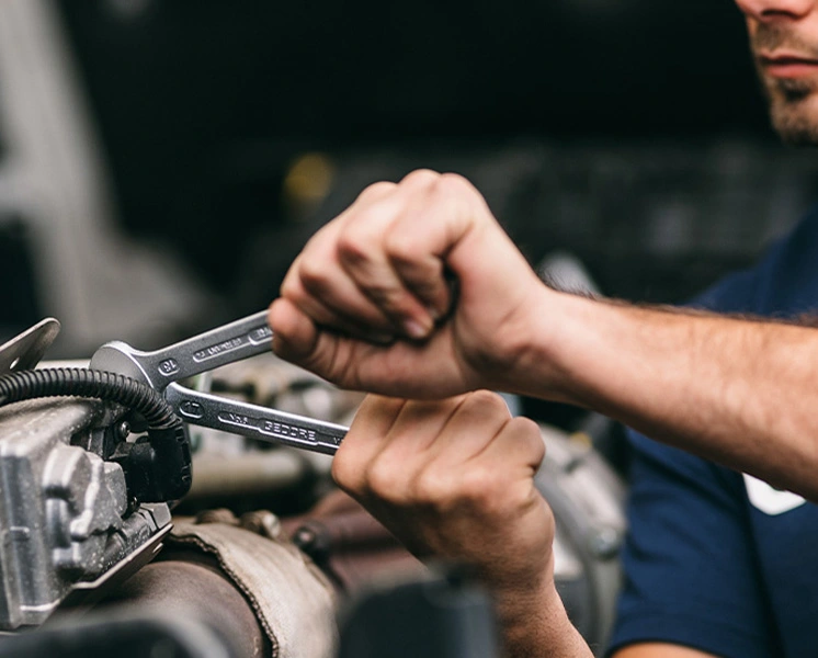 Mechanic working with GEDORE wrenches on heavy machinery
