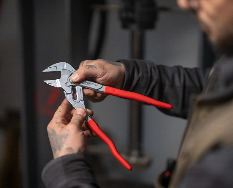 GEDORE red pliers wrench being adjusted by a user